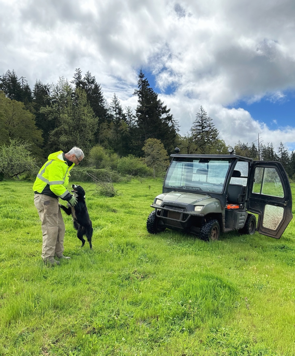 Doug with his dog and the Polaris on the ranch